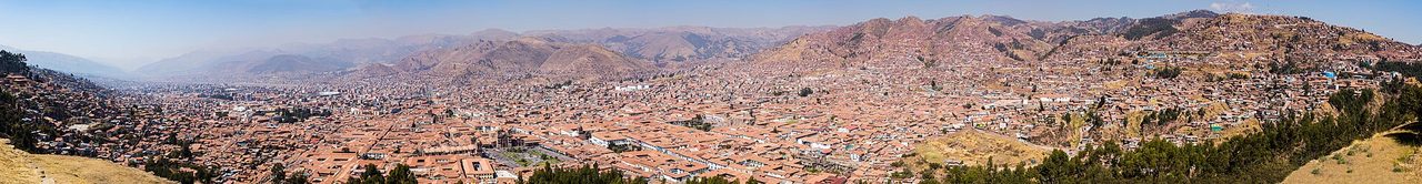The red-tiled rooftops of Cusco spread across its Andean valley