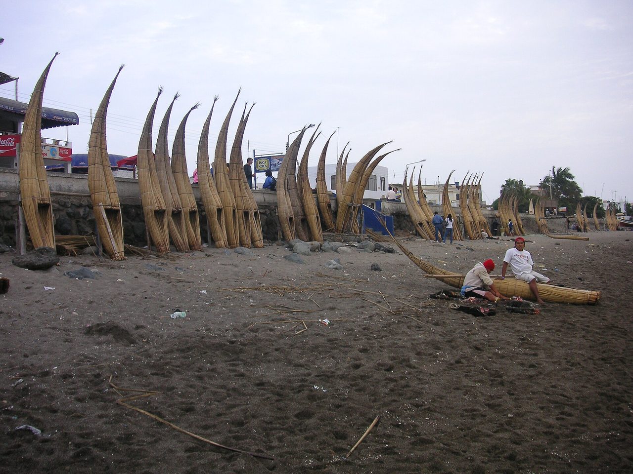 Traditional caballitos de totora reed boats lined up on Huanchaco beach