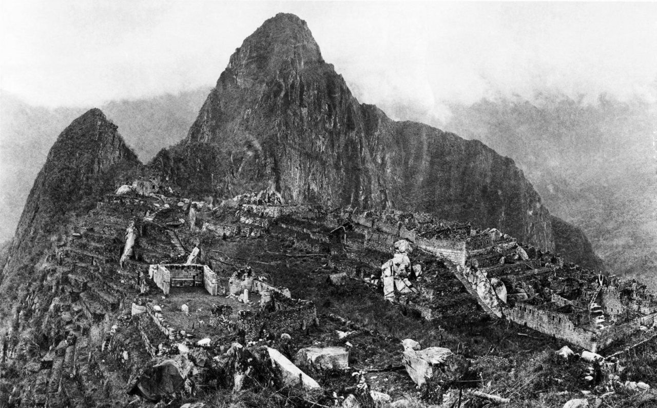 An early photograph of Machu Picchu from the Hiram Bingham expedition era, terraces still half-buried in vegetation