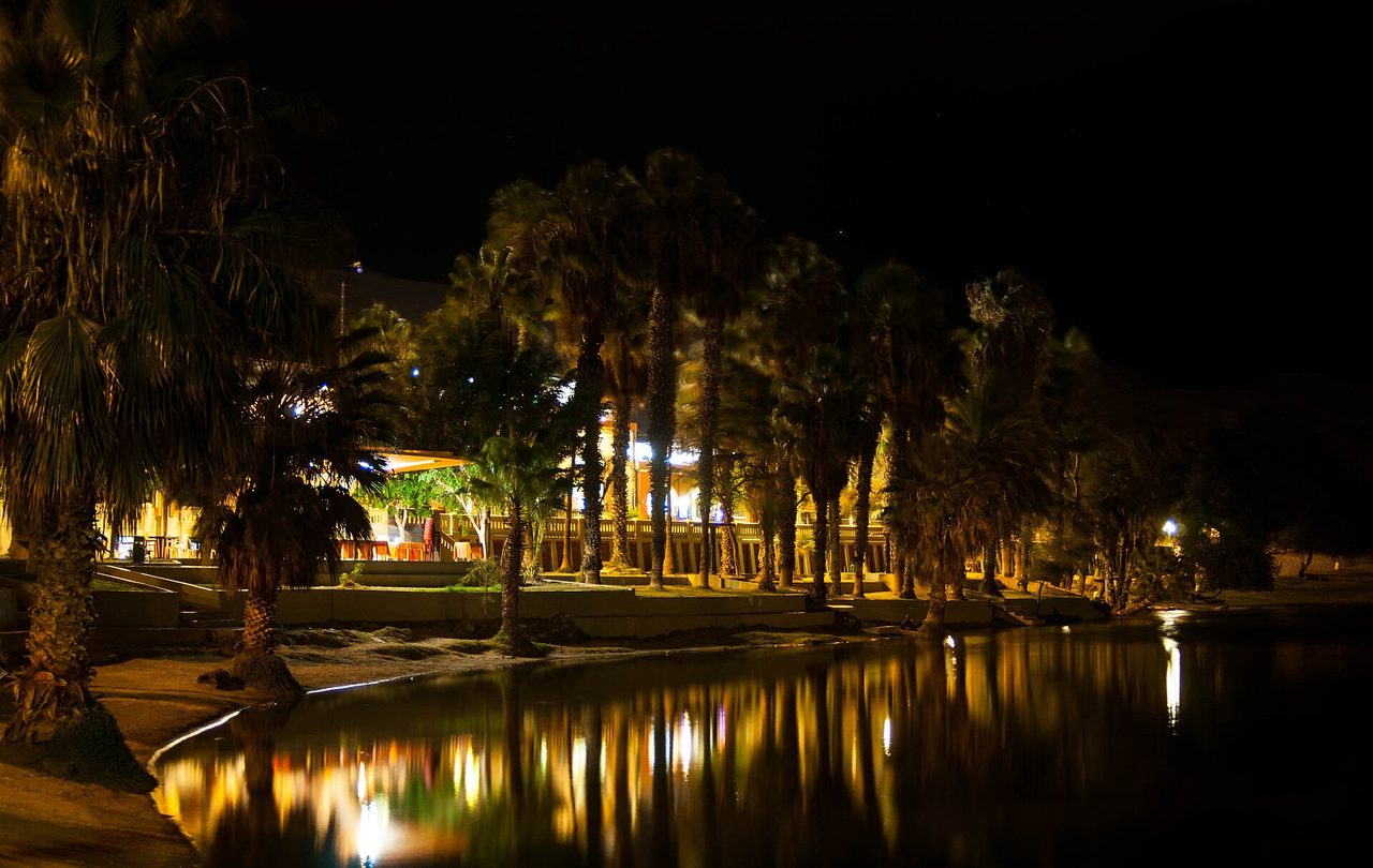 The desert oasis of Huacachina ringed by giant sand dunes
