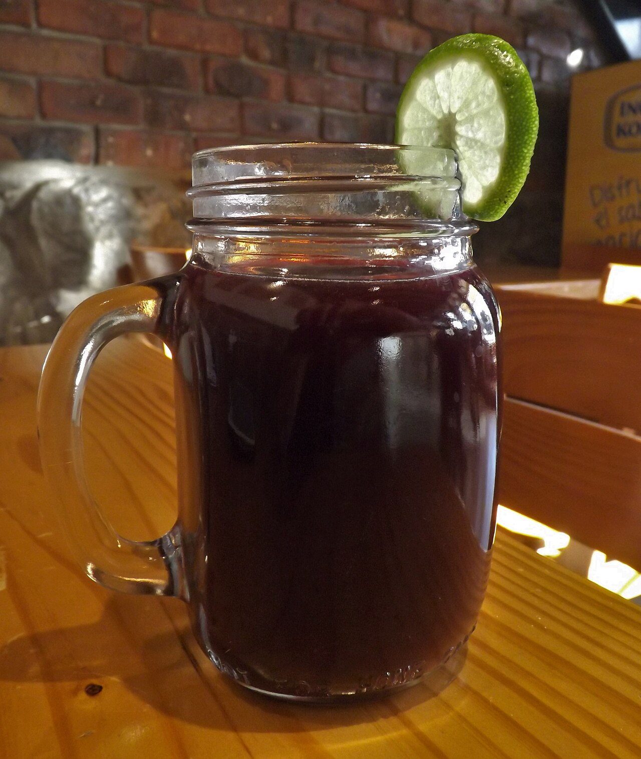 Chicha morada, a sweet Peruvian drink made from purple corn, served with a lime wheel