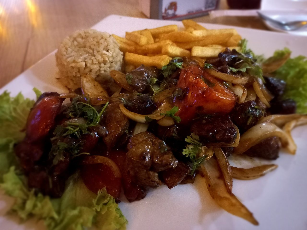 Lomo saltado, a Peruvian beef stir-fry served with French fries and white rice