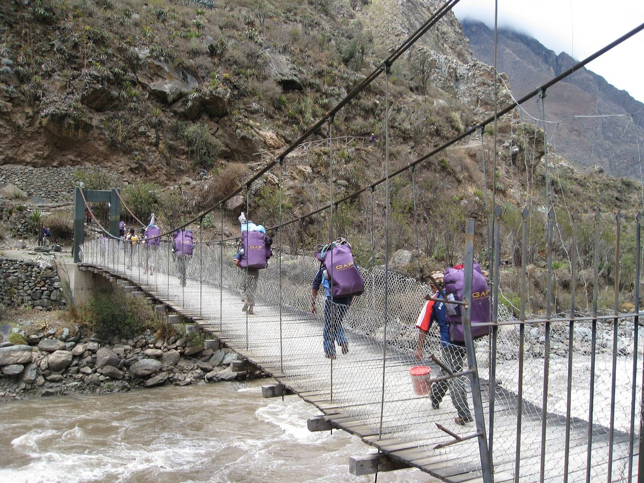 Porters carrying gear on the Inca Trail to Machu Picchu