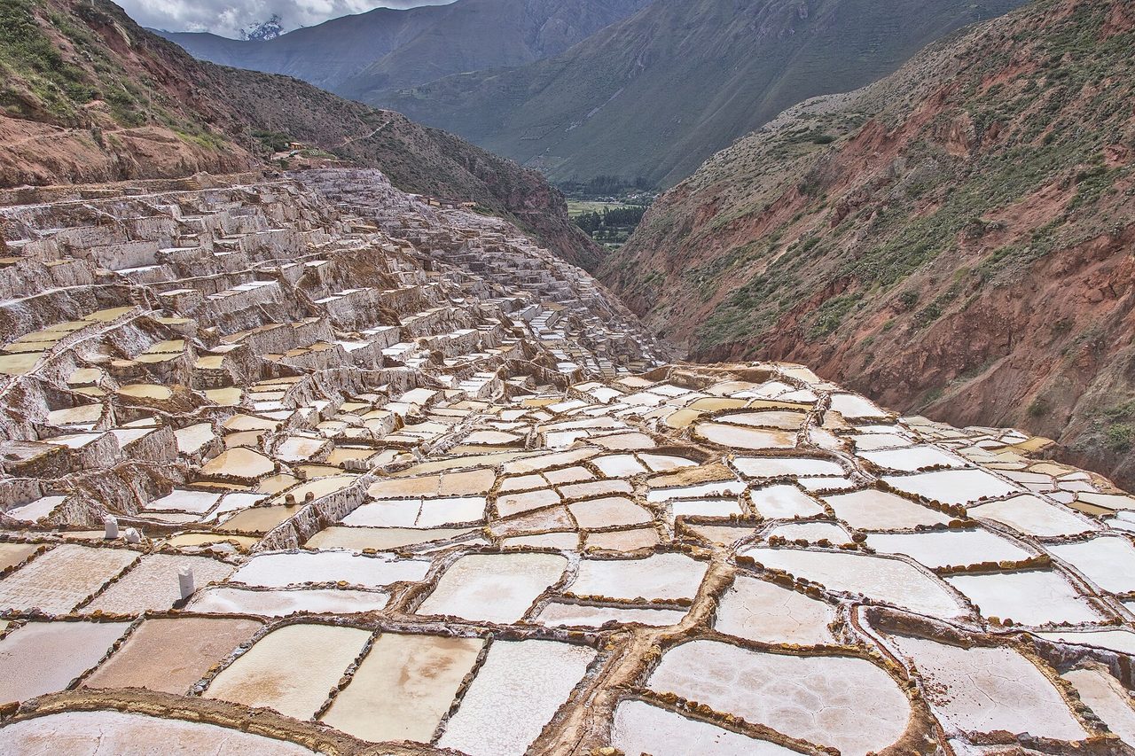 The tiered evaporation pools of the Maras salt pans stepping down a ravine in Peru's Sacred Valley