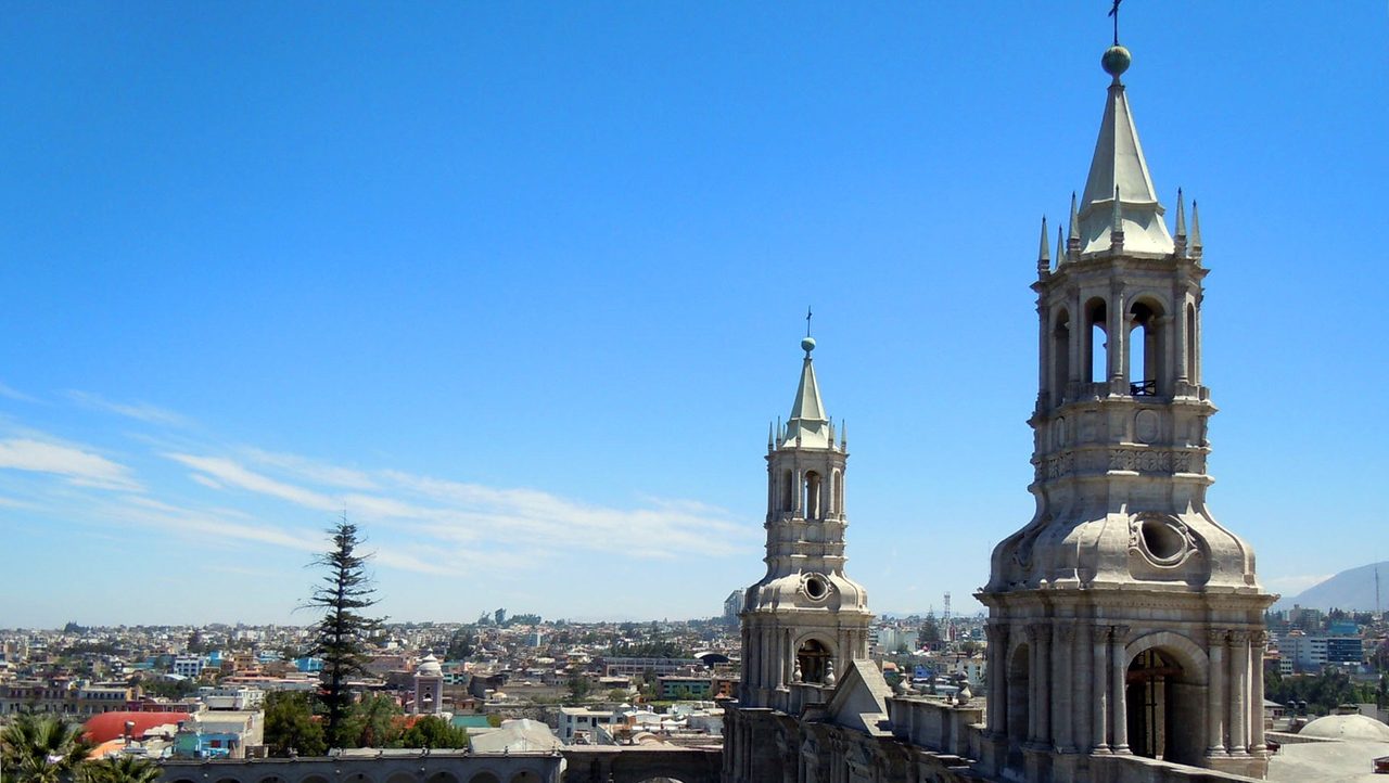 The twin bell towers of Arequipa's cathedral in pale sillar stone above the city rooftops