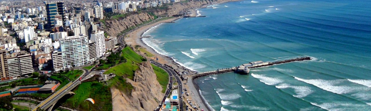Apartment towers on the clifftop in Miraflores, Lima, above the beaches and grey Pacific surf