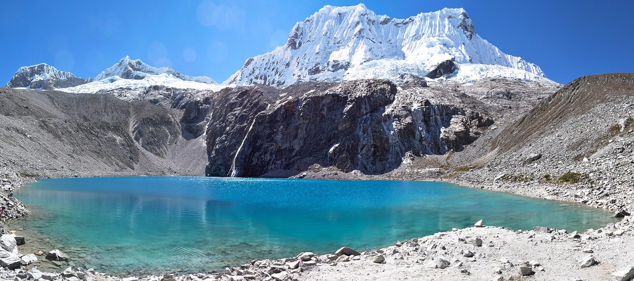 The turquoise water of Laguna 69 below a glaciated peak in Huascaran National Park