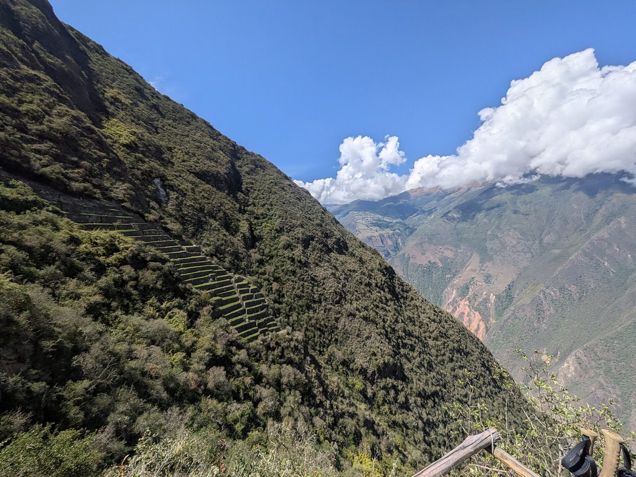 Looking down the steep slope below Choquequirao towards the Paqchayoq llama terrace sector, reached by a long staircase, with the Apurimac canyon beyond