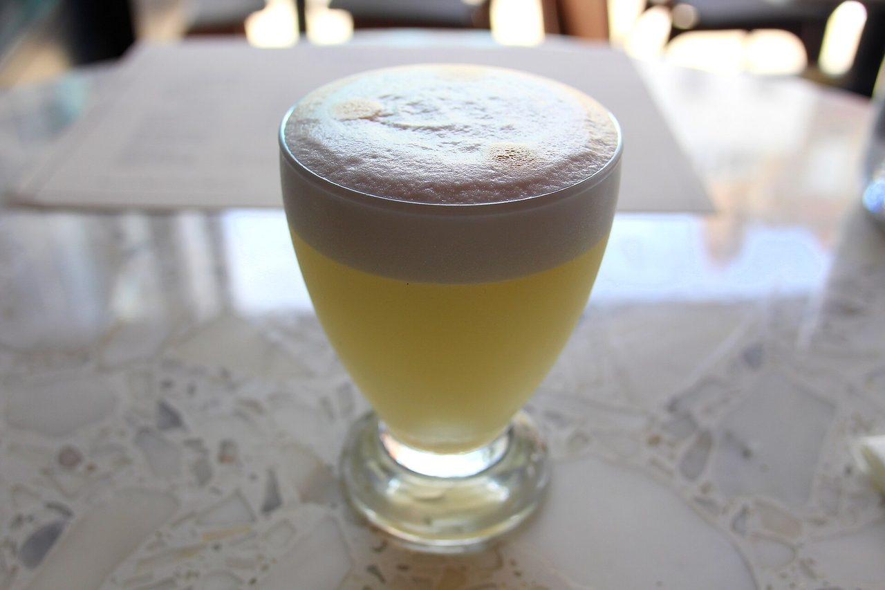 A pisco sour with its foamed egg-white head