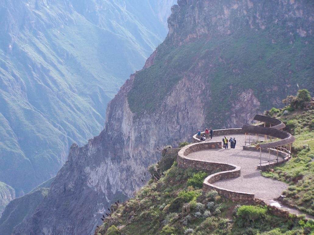 Visitors on the curved stone viewing platform at Cruz del Condor above the Colca Canyon