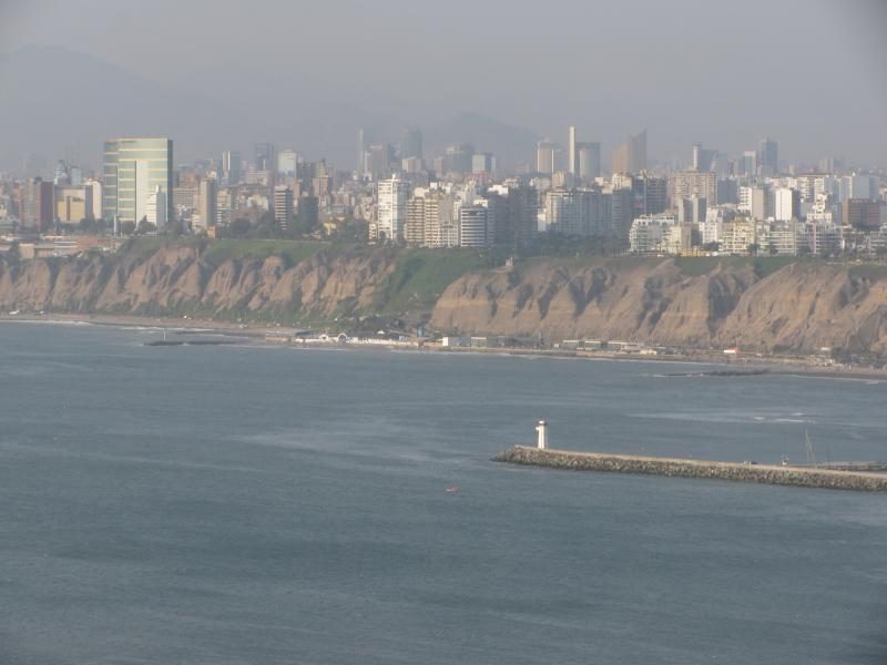 Lima seen from the coast at Chorrillos, cliffs and apartment towers fading into sea haze