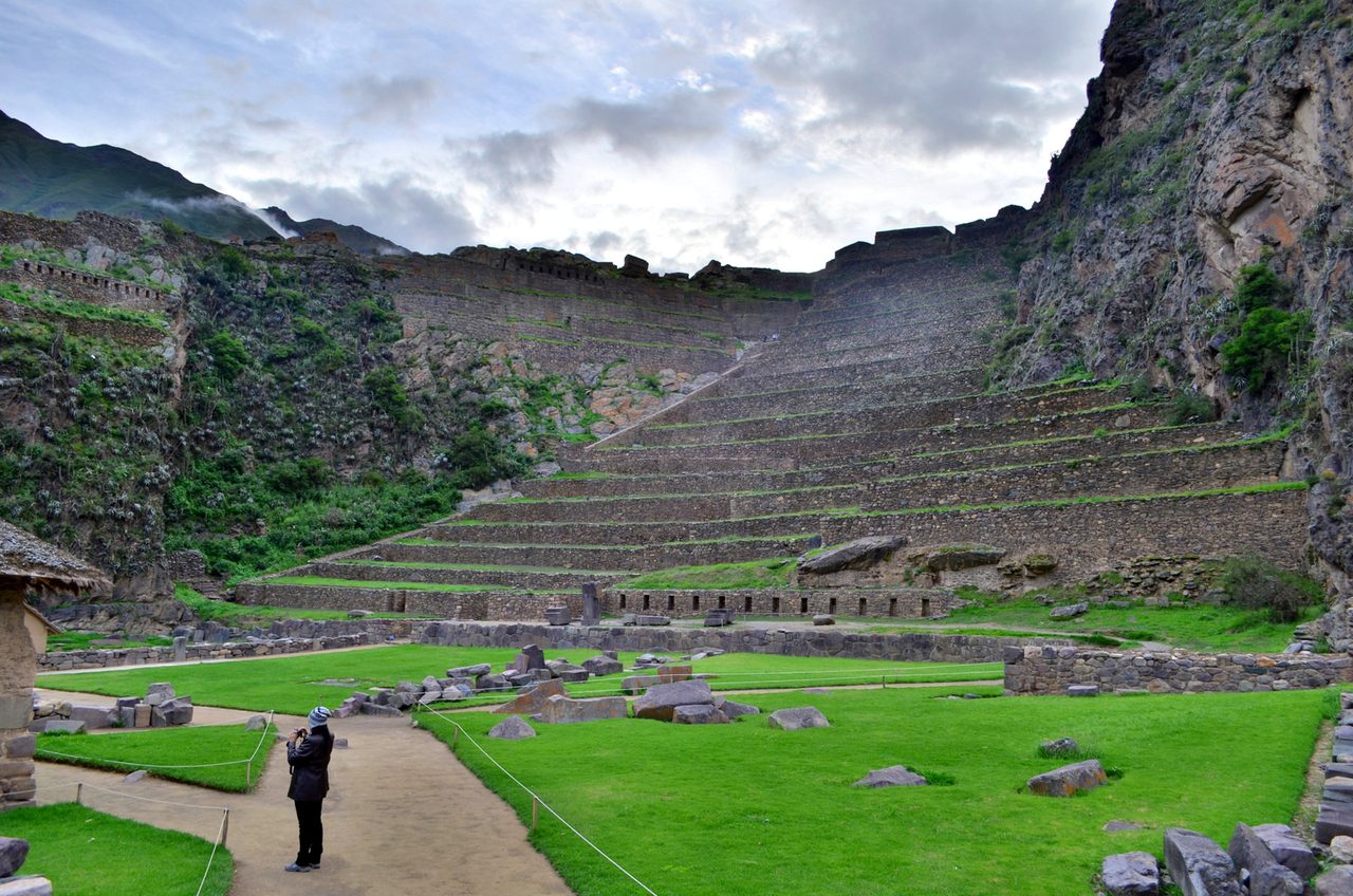 Steep stone agricultural terraces climbing the hillside above the Inca fortress at Ollantaytambo