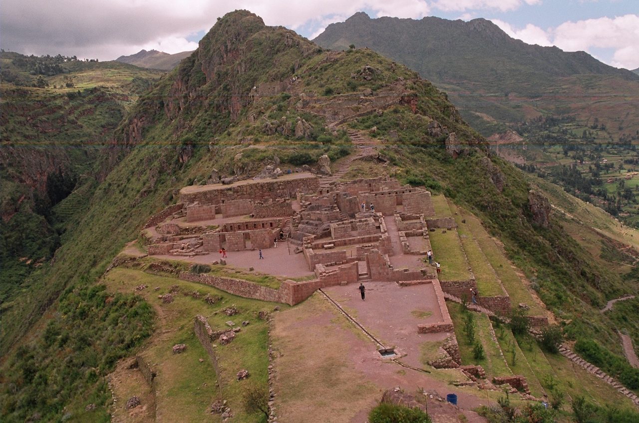 Stone buildings and plazas of the Pisac ruins strung along a narrow ridge above the Sacred Valley