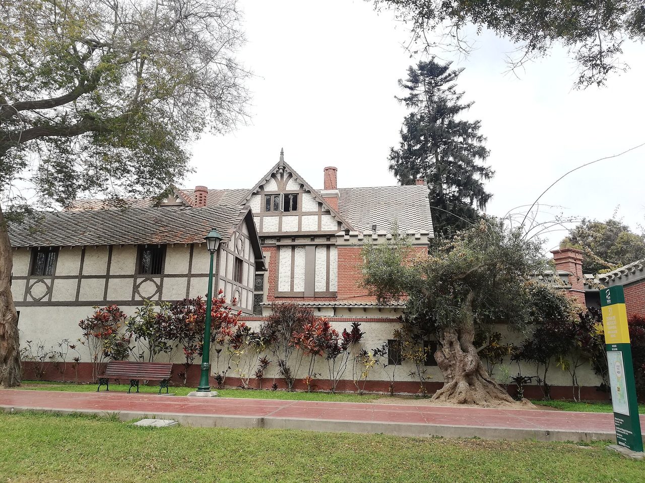 A half-timbered house facing the lawns and gnarled old olive trees of Parque El Olivar in San Isidro, Lima