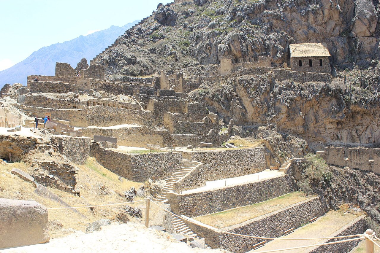 Dry brown hillsides above the Inca terraces at Ollantaytambo in the Sacred Valley under a clear sky