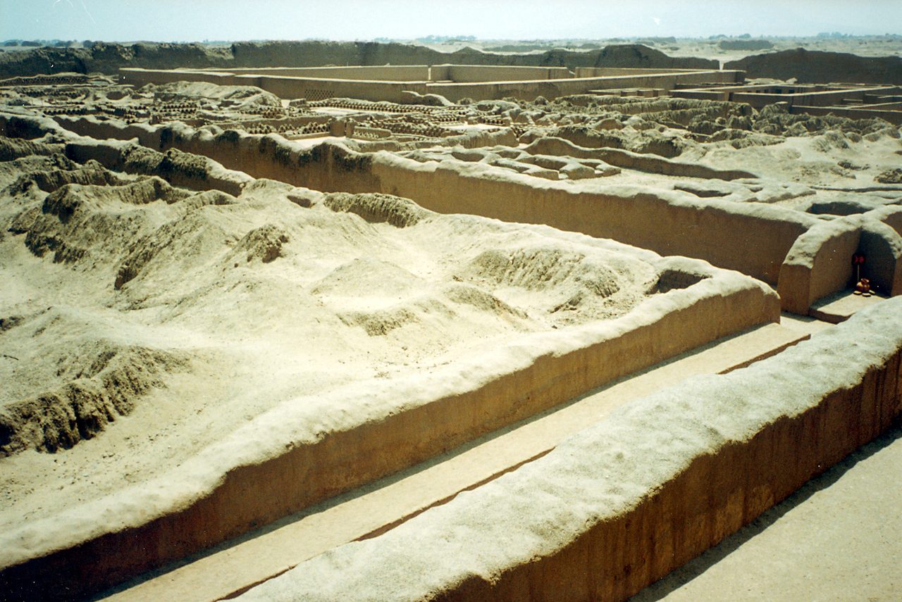 Eroded adobe walls, corridors and courtyards stretching to the horizon at the Chan Chan archaeological zone near Trujillo