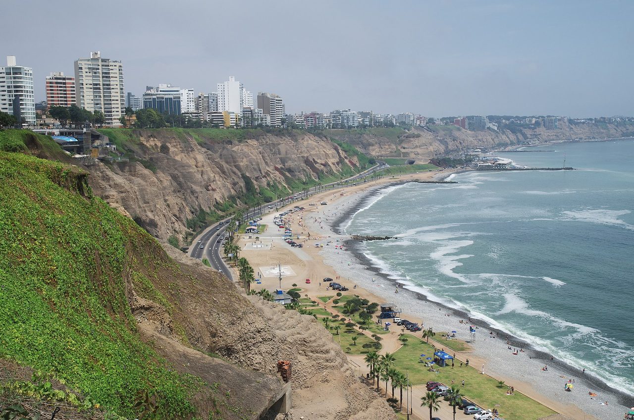 Grey hazy sky over the Costa Verde cliffs, coast road and beach in the Miraflores district of Lima