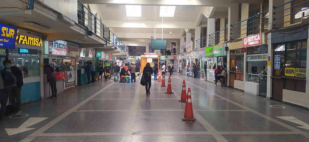 The ticket-counter concourse of Cusco's long-distance bus terminal, with agency windows selling seats to Arequipa, Puno and Lima