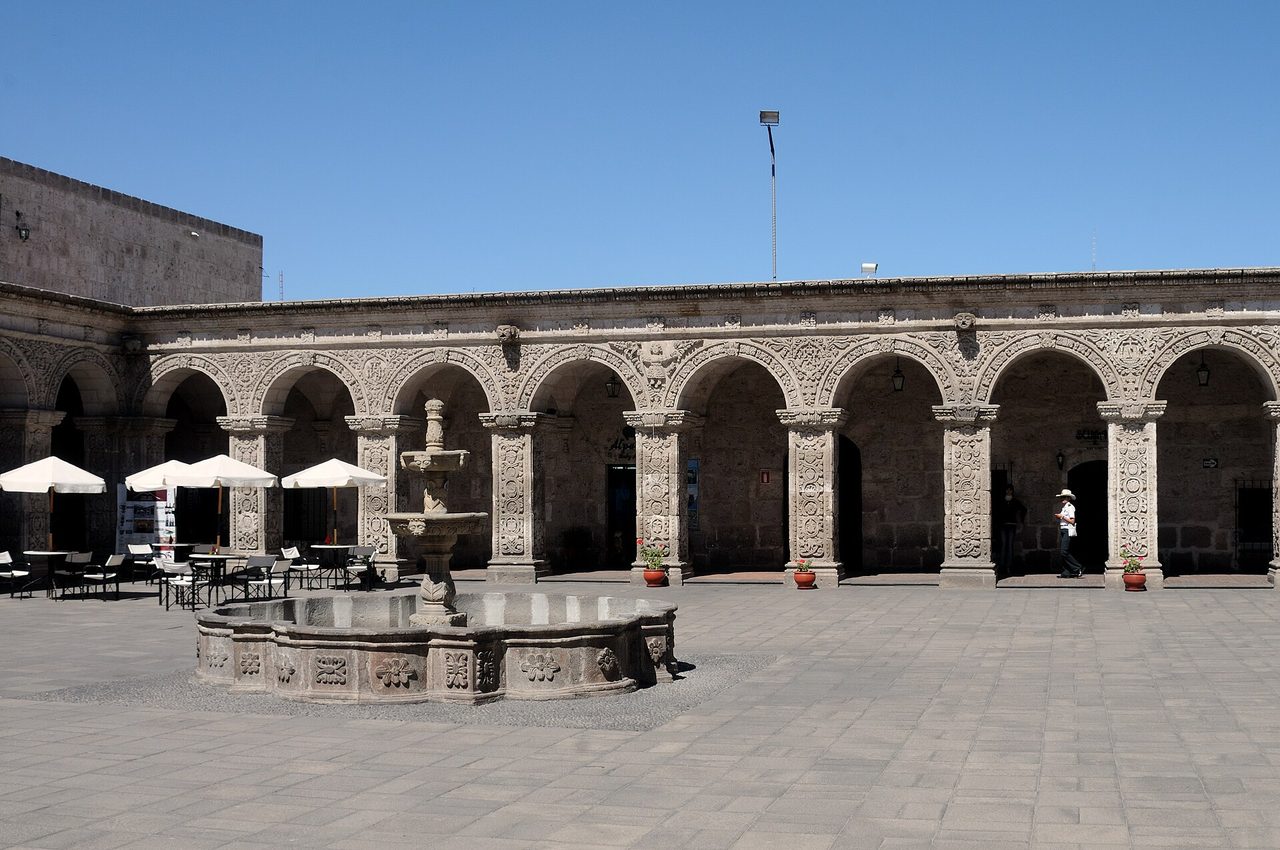 Carved sillar stone cloisters and a fountain in the courtyard of the Jesuit church complex in Arequipa