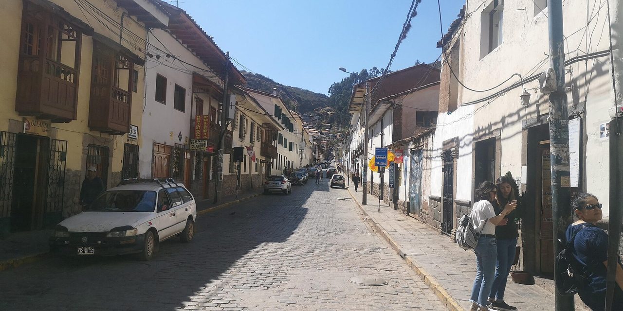 Calle Choquechaca, a cobbled street below the San Blas neighbourhood of Cusco, with hillside housing behind