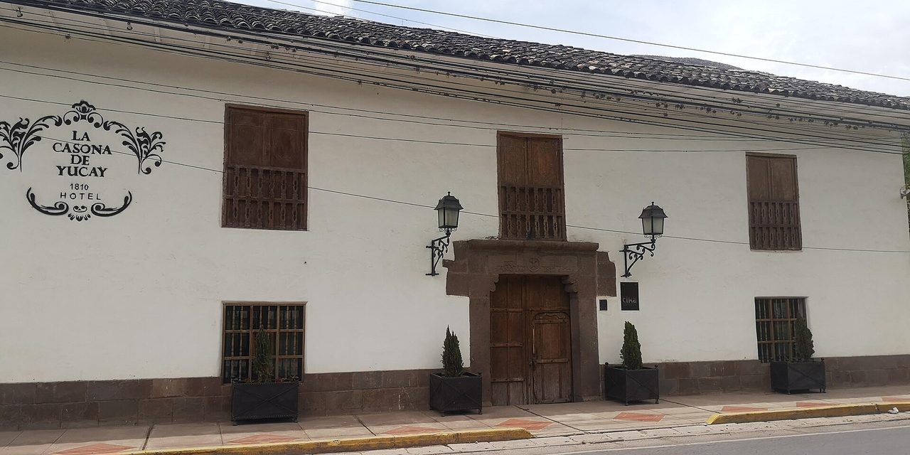The whitewashed colonial facade of an old casona in Yucay, now run as a hotel, fronting straight onto the village road